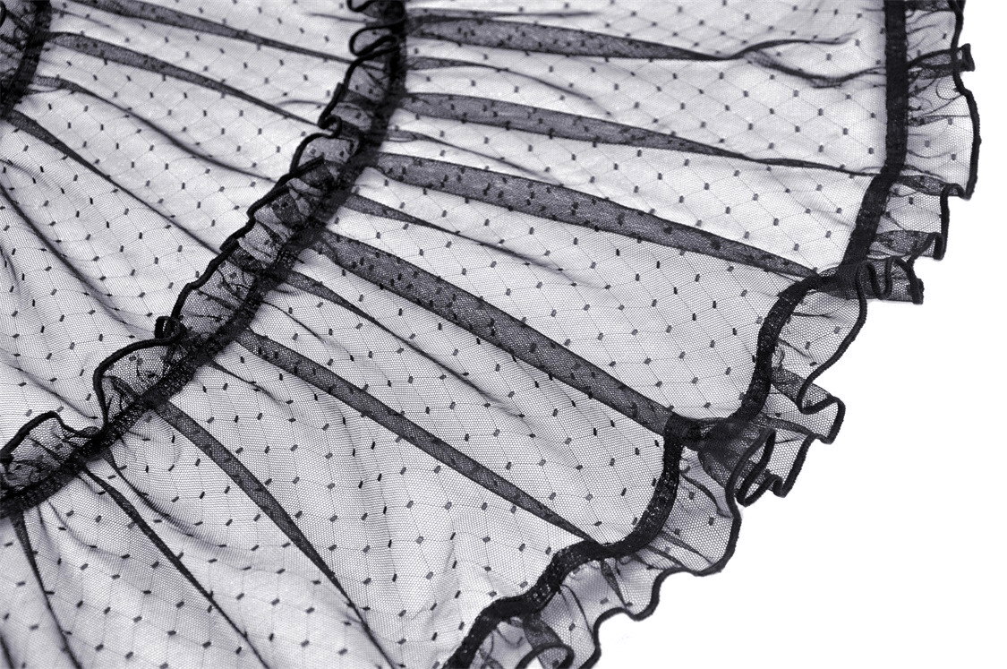 Close-up of black lace mesh skirt with polka dot pattern and ruffled edges, showcasing gothic elegance.
