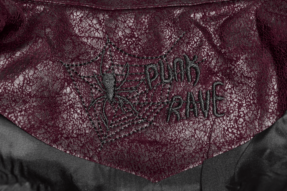 Embroidered spider design on burgundy leather, featuring 'Punk Rave' for a gothic vibe.