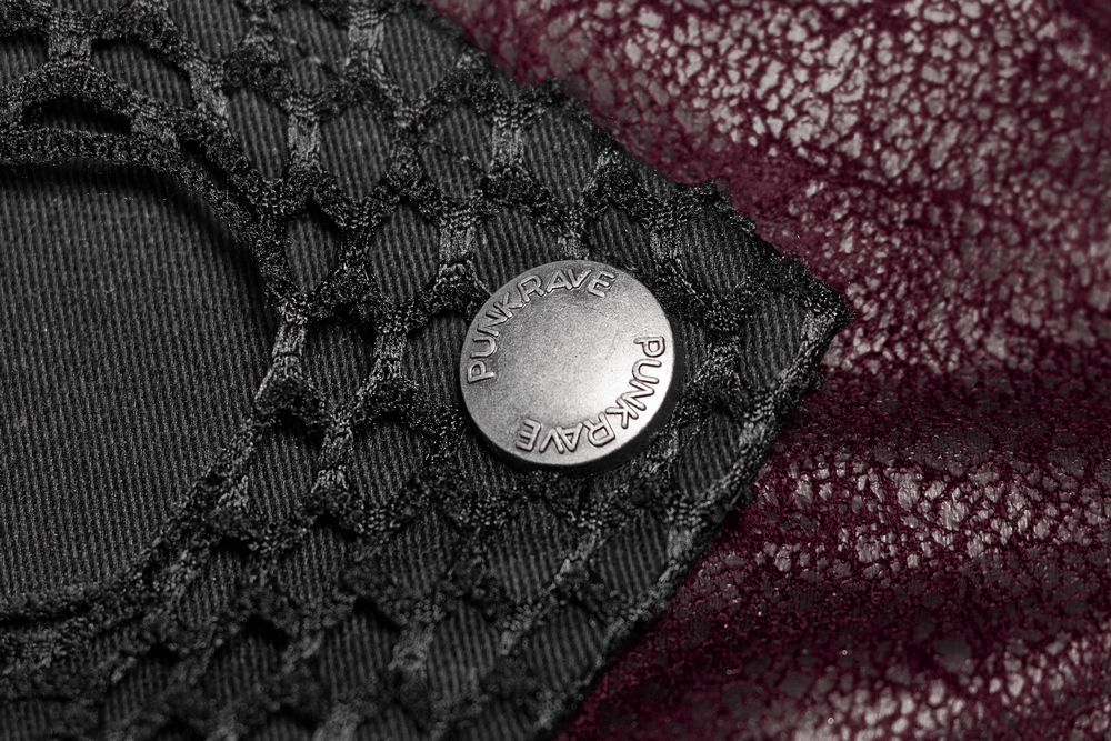 Detail of gothic male leather trench coat featuring laced sleeve and metal logo button.