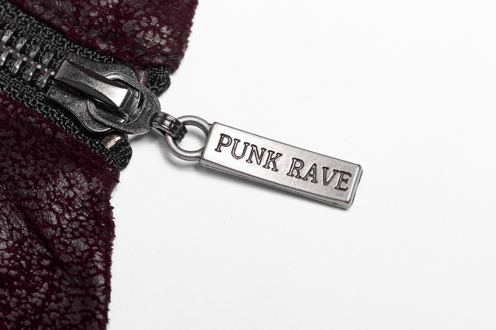 Close-up of the zipper pull with 'PUNK RAVE' label on a burgundy leather trench coat.