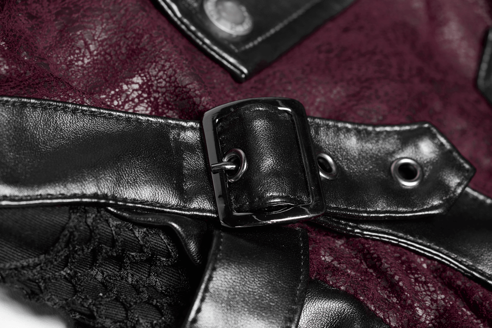 Close-up of the buckle detail on a burgundy leather gothic trench coat with laced sleeves.