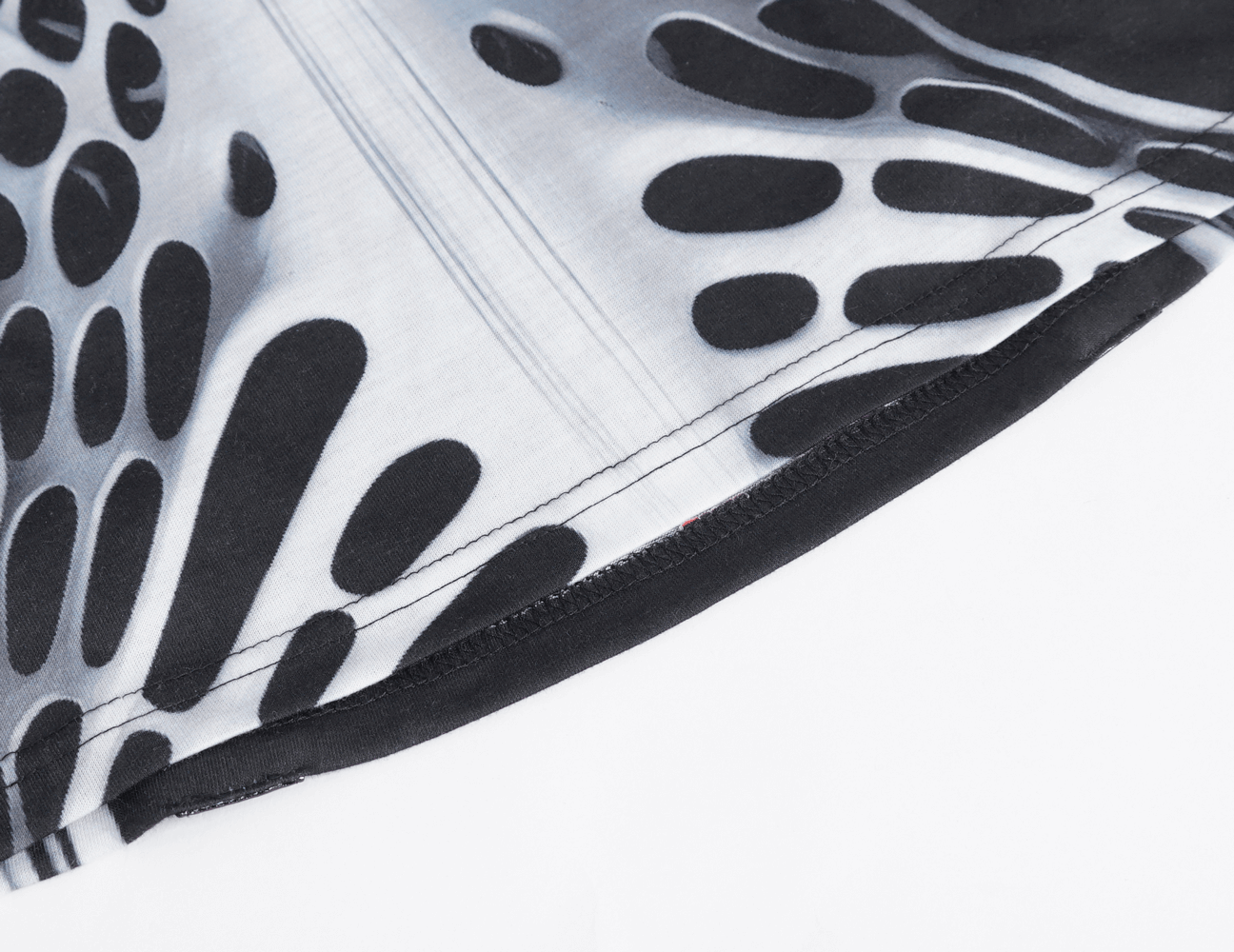 Close-up of black and white fabric showcasing unique pattern for Gothic male tank top.