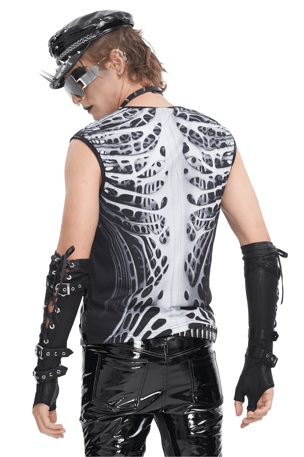 Gothic male wearing a skeleton graphic tank top with edgy rivets and sleek black pants.