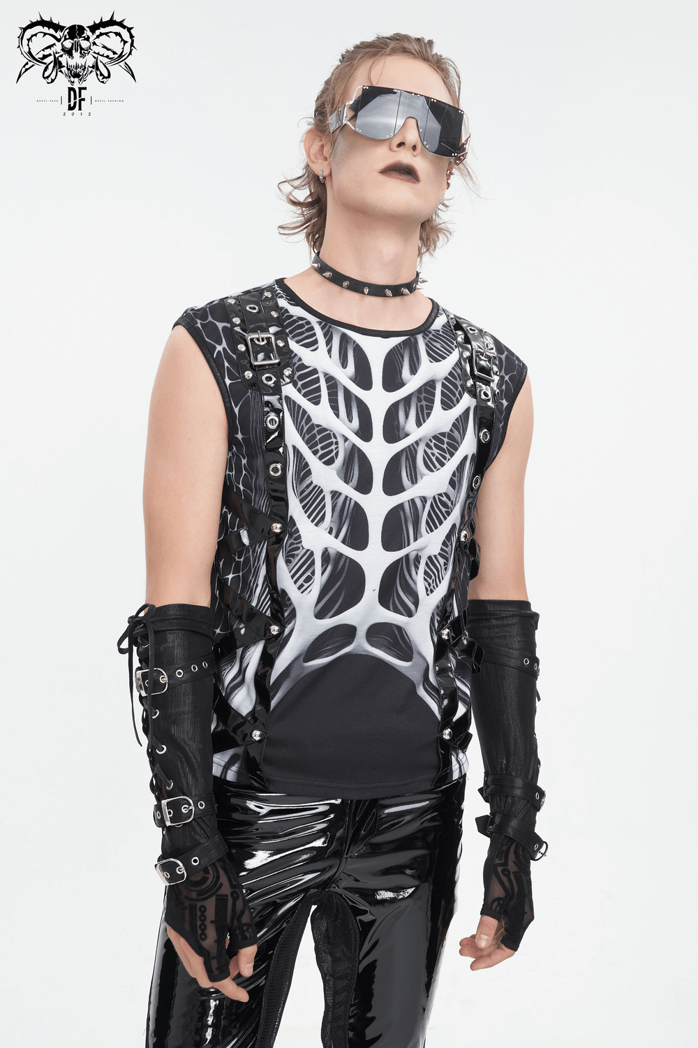 Stylish male model wearing a gothic tank top with skeleton graphic and edgy accessories, exuding rockstar vibes.