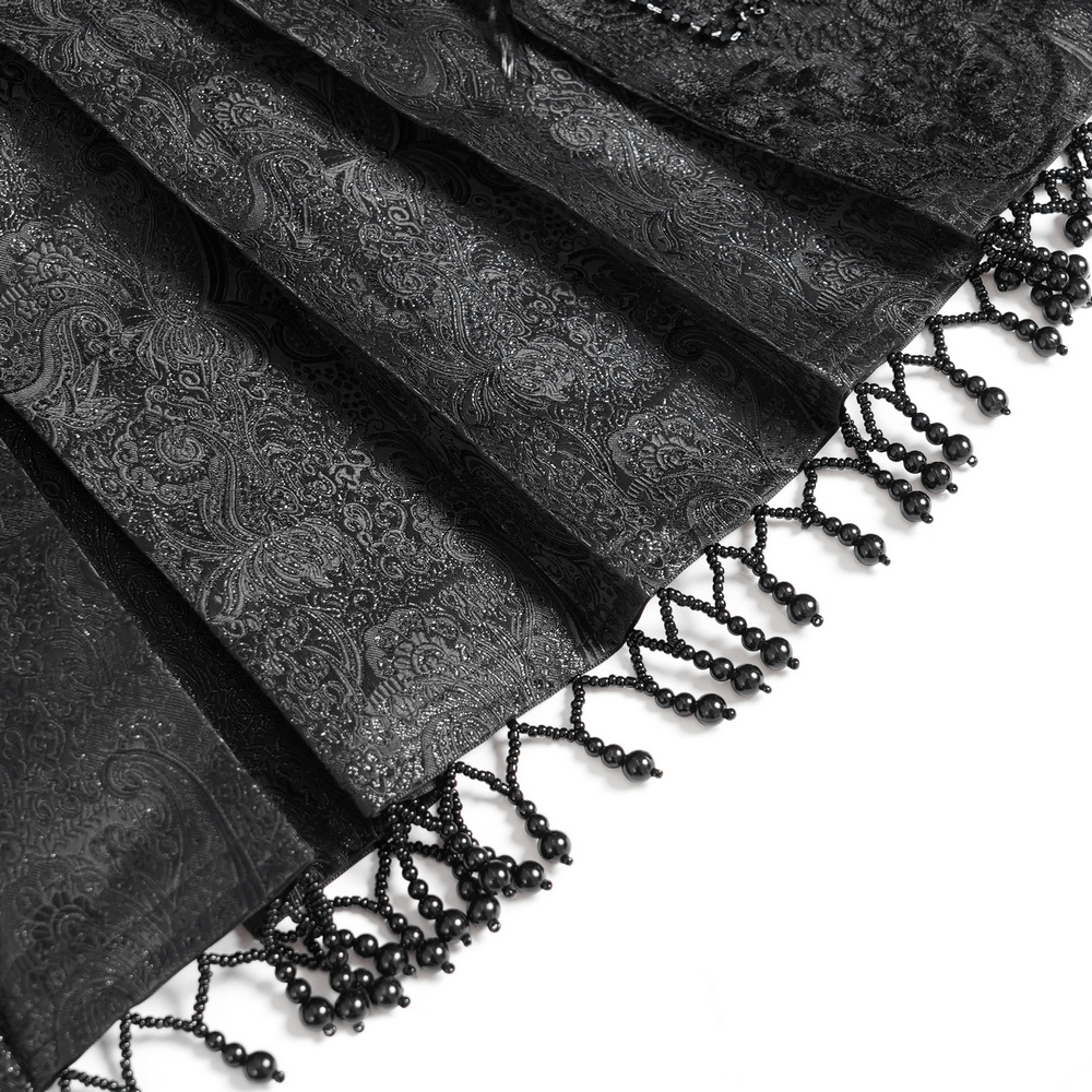 Close-up of a gothic black maxi skirt featuring intricate lace trim and beaded detailing, showcasing vintage elegance.