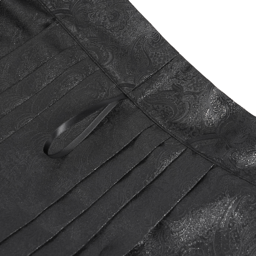 Close-up of the intricate luxurious fabric and pleats of the Gothic maxi skirt, showcasing the elegant black jacquard pattern.
