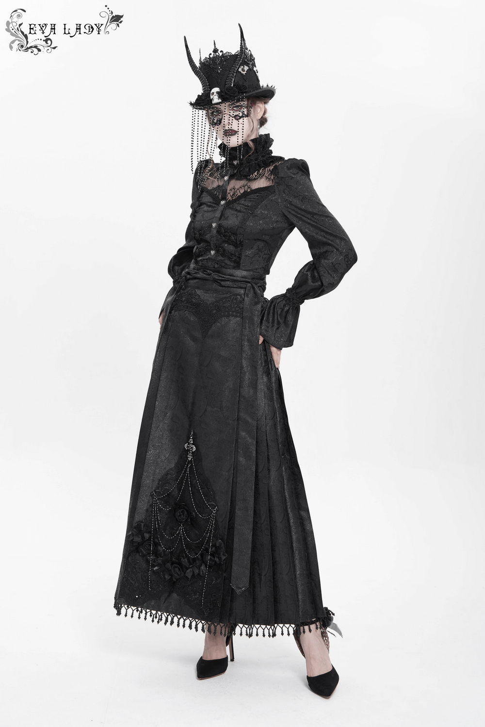 Gothic model wearing an elegant black maxi skirt with lace details and a vintage hat, showcasing dark fashion style.