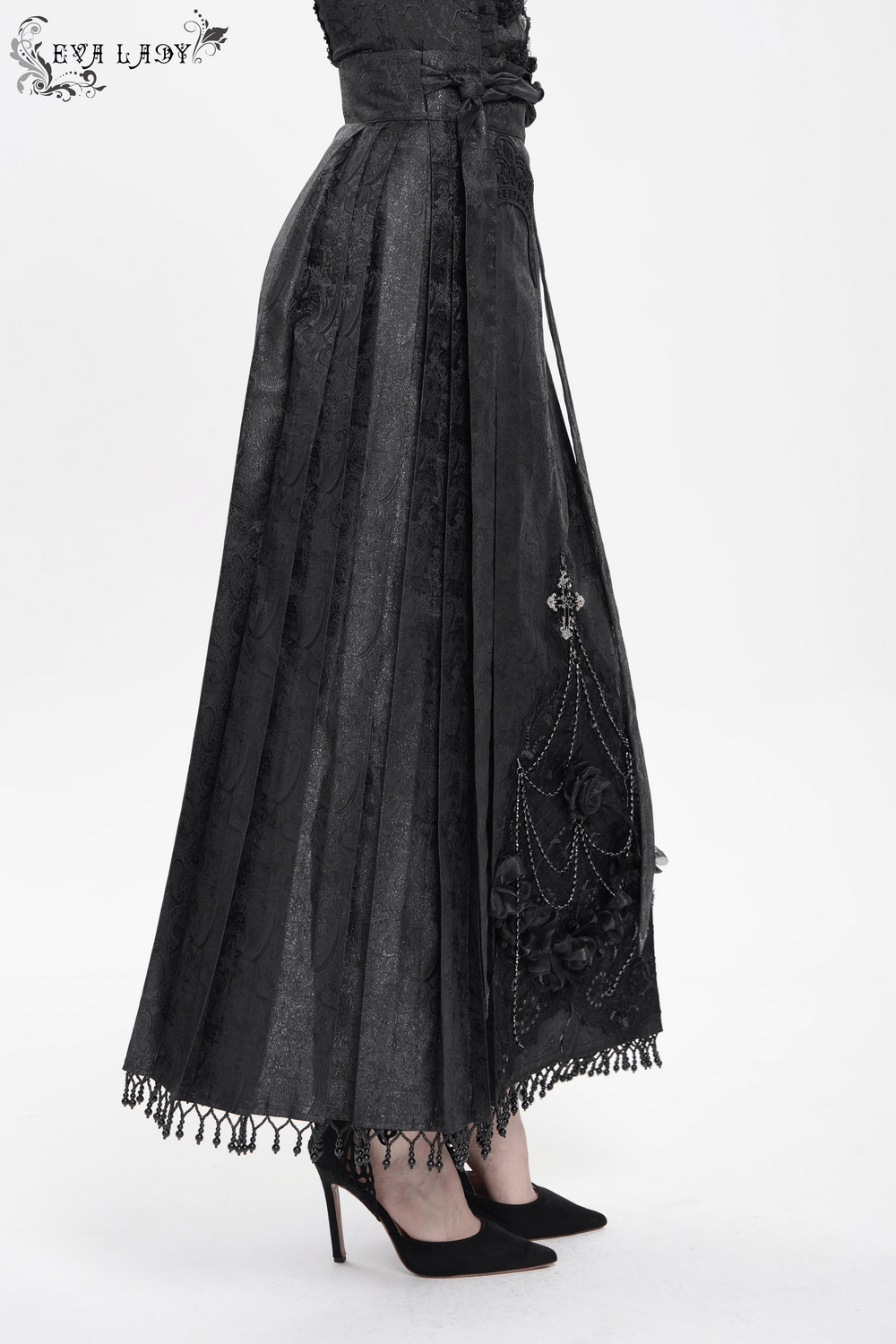 Gothic maxi skirt with lace trim, cross pendant, and dramatic rose chain details in black fabric.