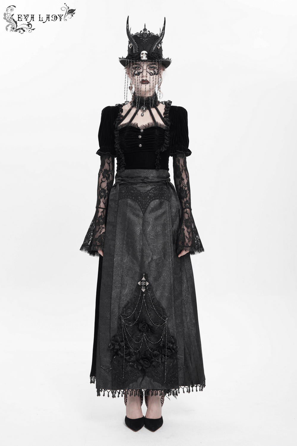 Gothic maxi skirt with lace trim and dramatic chains, styled with a black top and statement accessories for dark elegance.