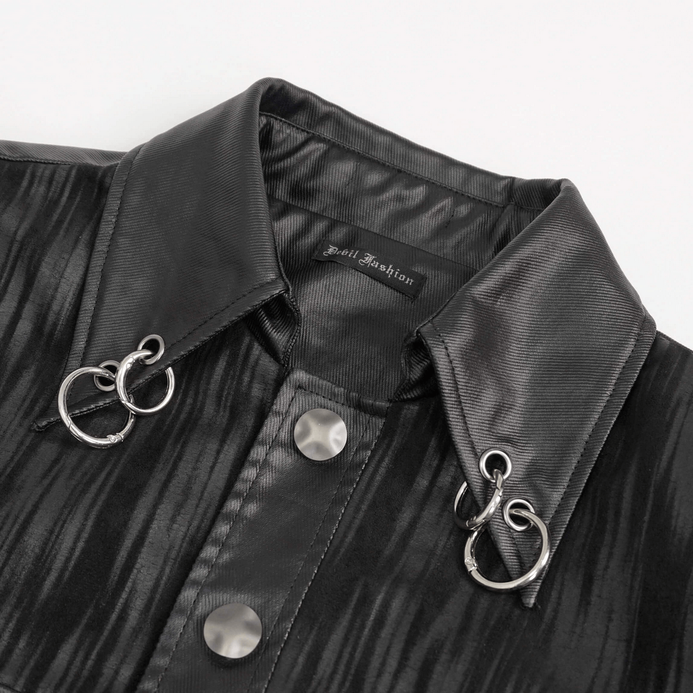 Close-up of gothic men's short jacket collar featuring stylish metal eyelets and rings in black fabric.