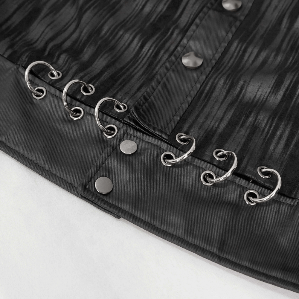 Close-up of gothic men's short jacket showing metal eyelets and rings against a black striped fabric.