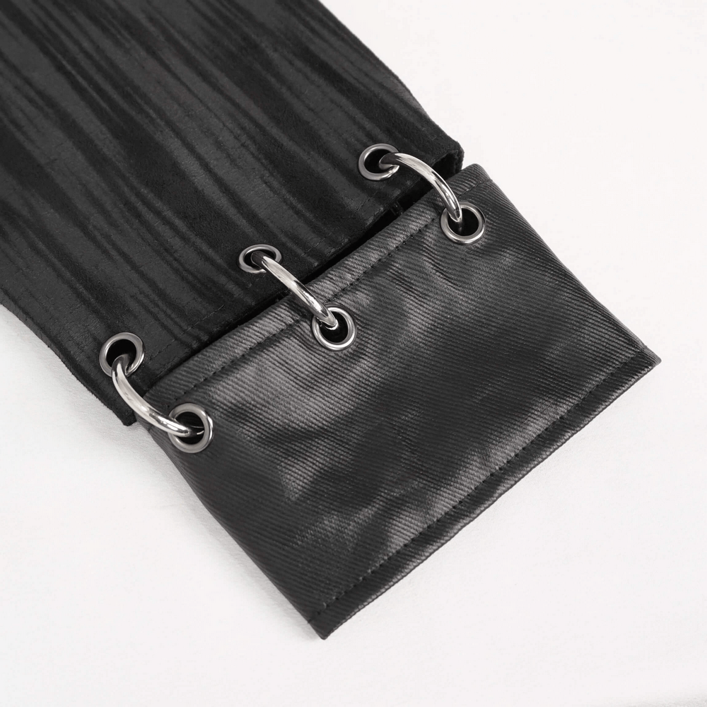 Close-up of gothic men's jacket sleeve showing metal eyelets and rings detail on stylish black fabric.