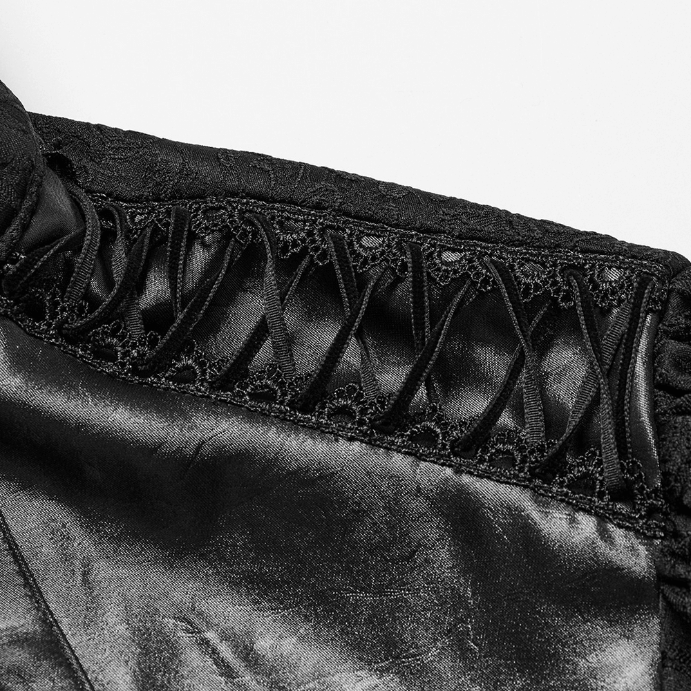 Close-up of Gothic men's black shirt showcasing intricate lace trim and drawstrings on the shoulder.