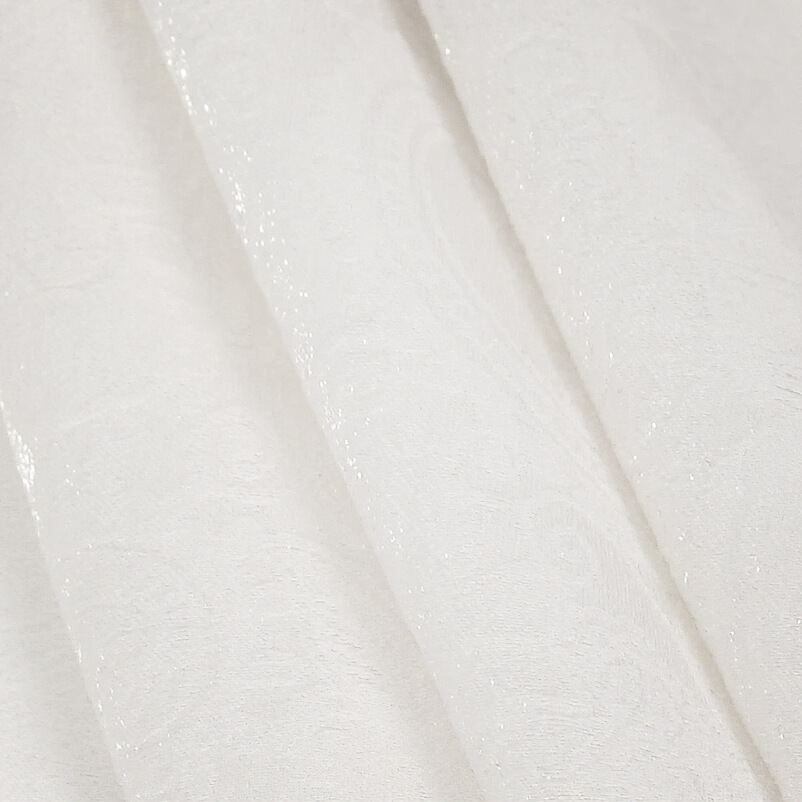Close-up of elegant white fabric with intricate floral embossing texture.