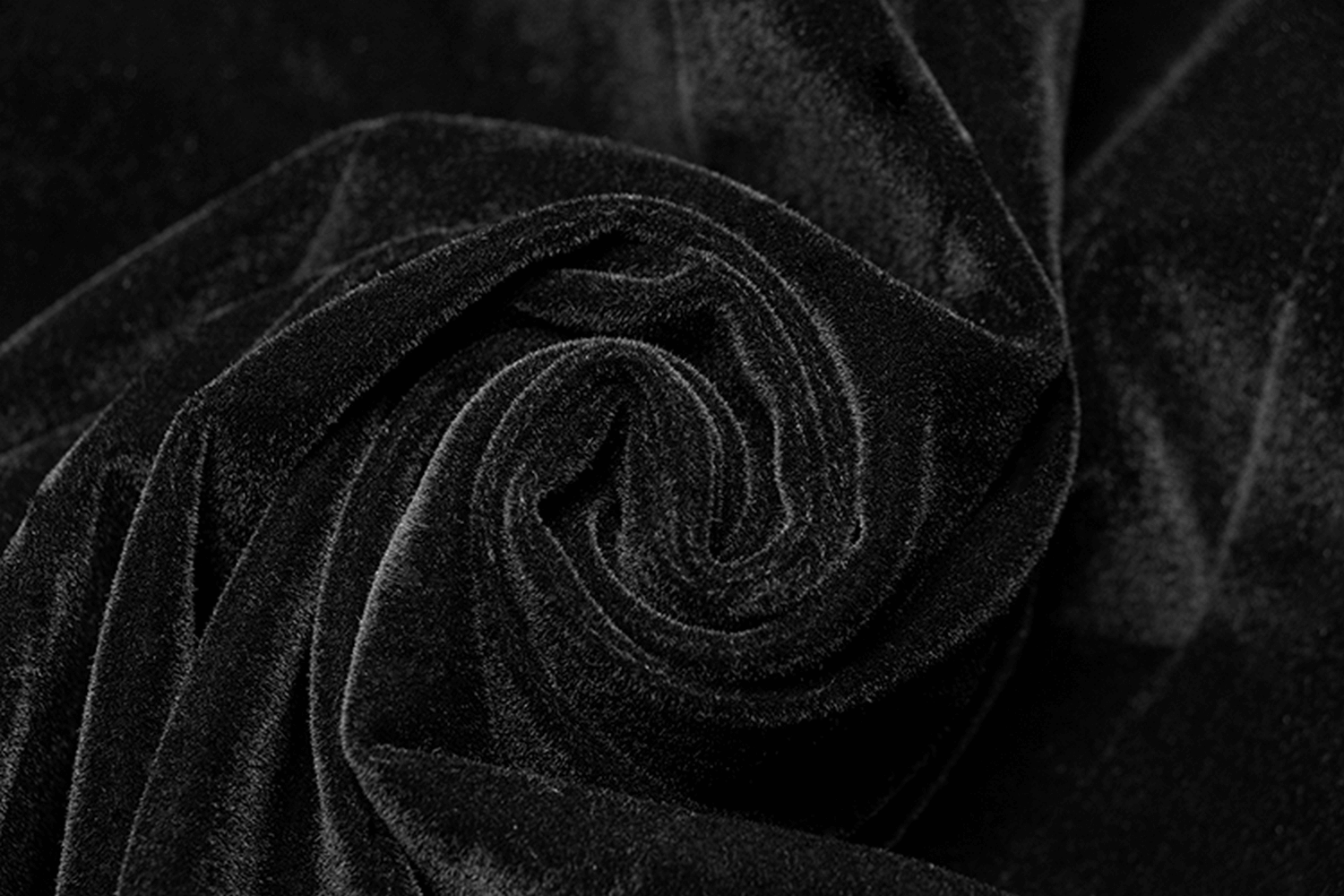 Close-up of luxurious black velvet fabric, perfect for crafting Gothic men's apparel.