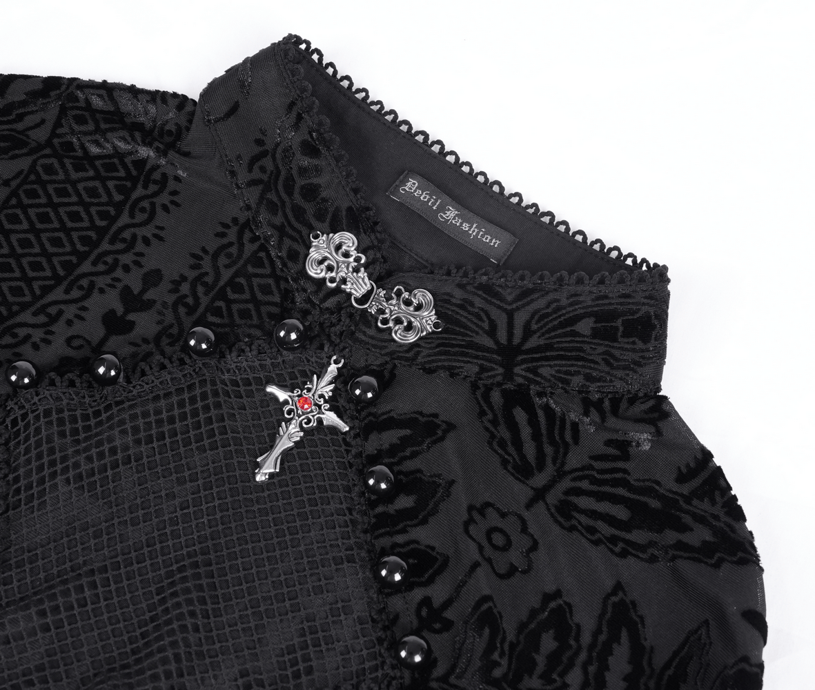 Close-up of Gothic top featuring intricate lace, mesh, and a stylish brooch detail.