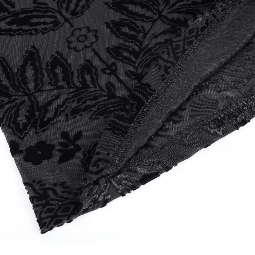 Close-up of intricate lace fabric featuring dark floral patterns, ideal for gothic fashion designs.