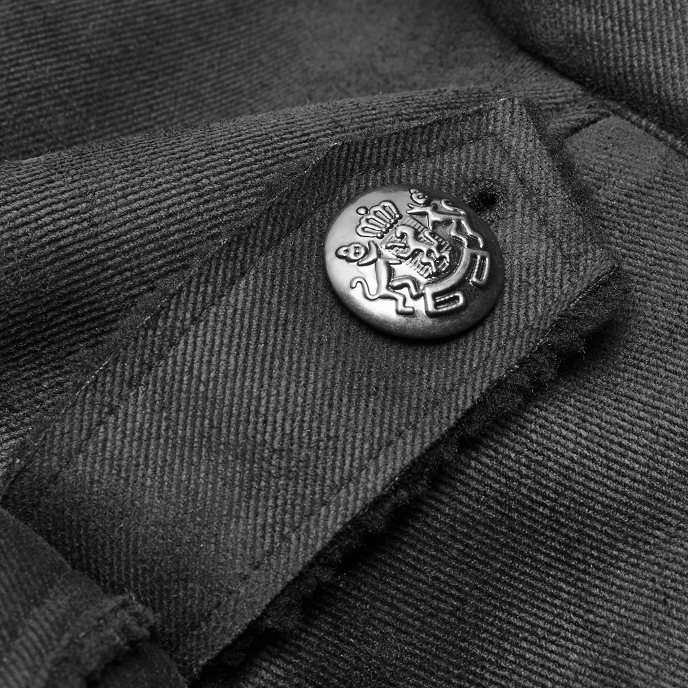 Close-up of a regal button accent on a gothic military-inspired long coat.