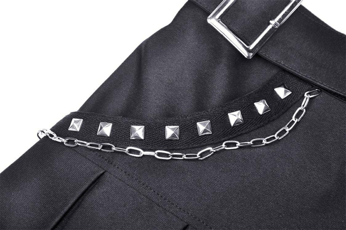 Close-up of black skirt fabric with studded details and chain accents, showcasing edgy gothic fashion style.