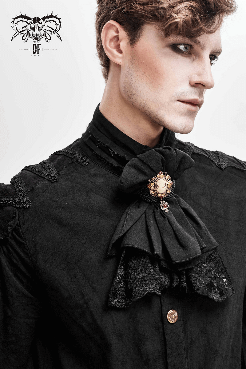 Elegant man in vintage gothic attire showcasing a black bow tie with lace and brooch accessory.
