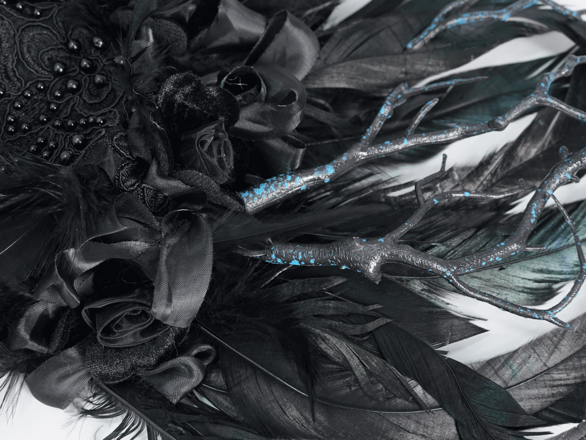 Elegant Gothic Noir feather crown with floral accents and intricate detailing, perfect for special events.