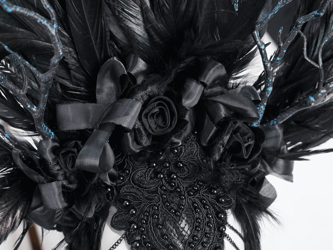 Gothic Noir feather crown with floral accents, featuring black feathers and elegant ribbons for special events.