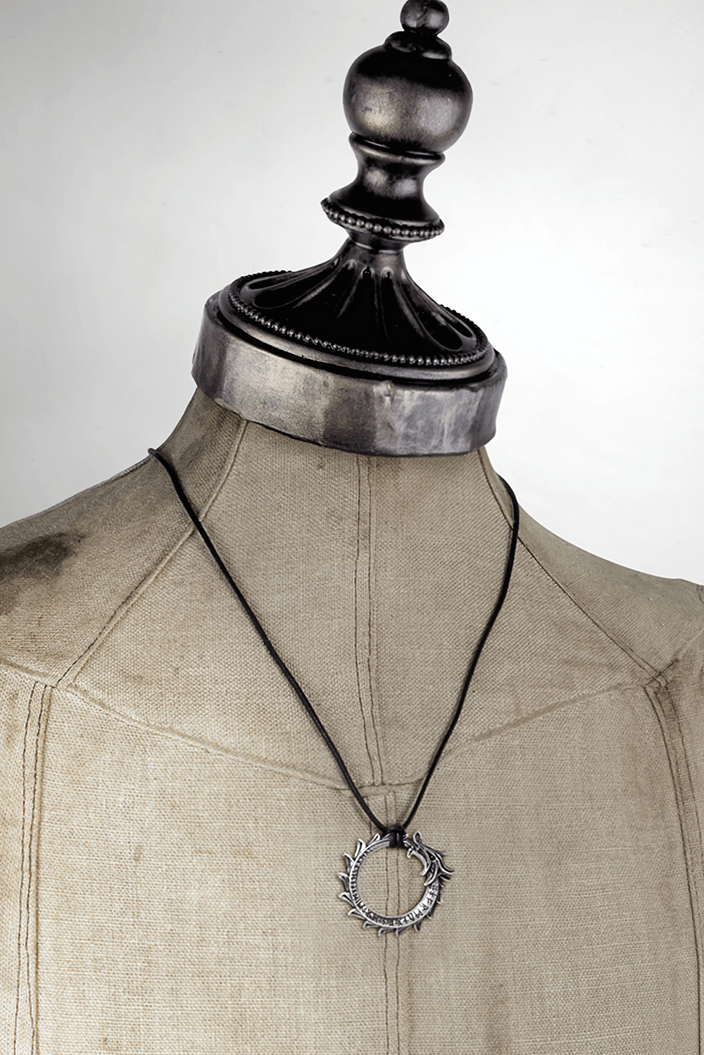 Gothic Norse Dragon Ouroboros Pendant Necklace displayed on a mannequin with a rugged black cord.