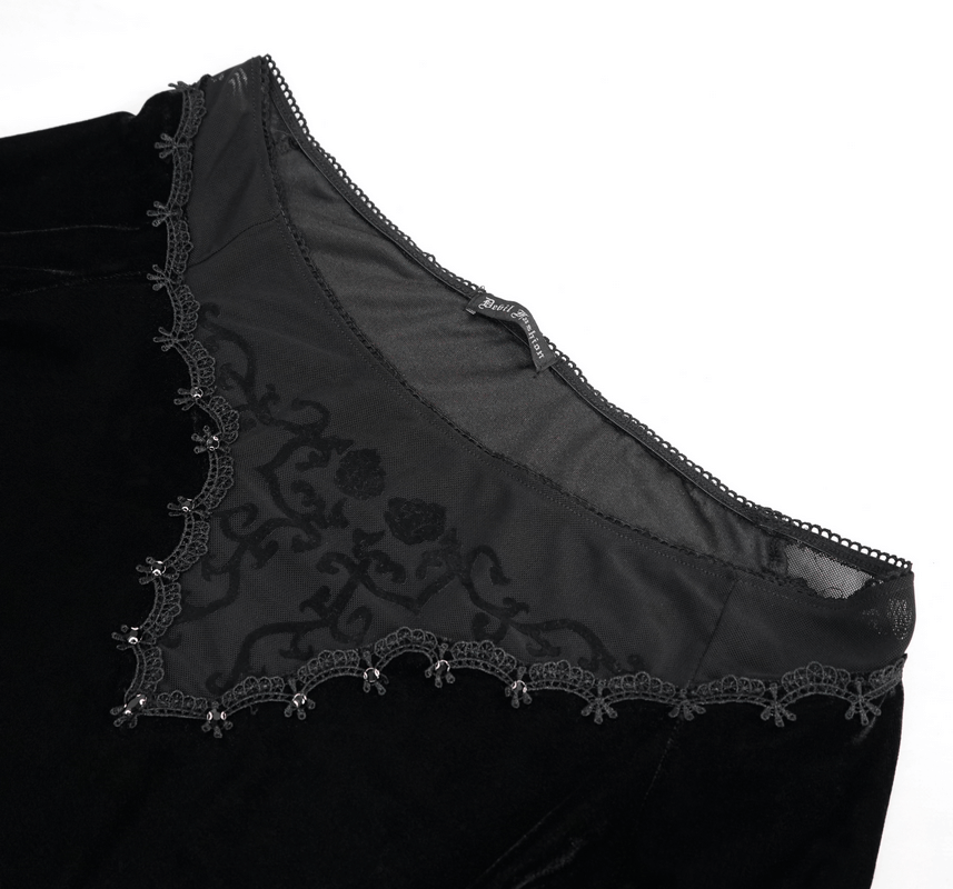 Close-up of gothic off-shoulder black velvet top with floral lace detailing and elegant trim.