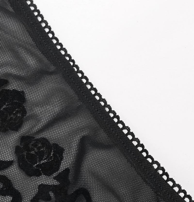 Close-up of black floral embroidery with lace trim, showcasing gothic elegance and intricate design details.