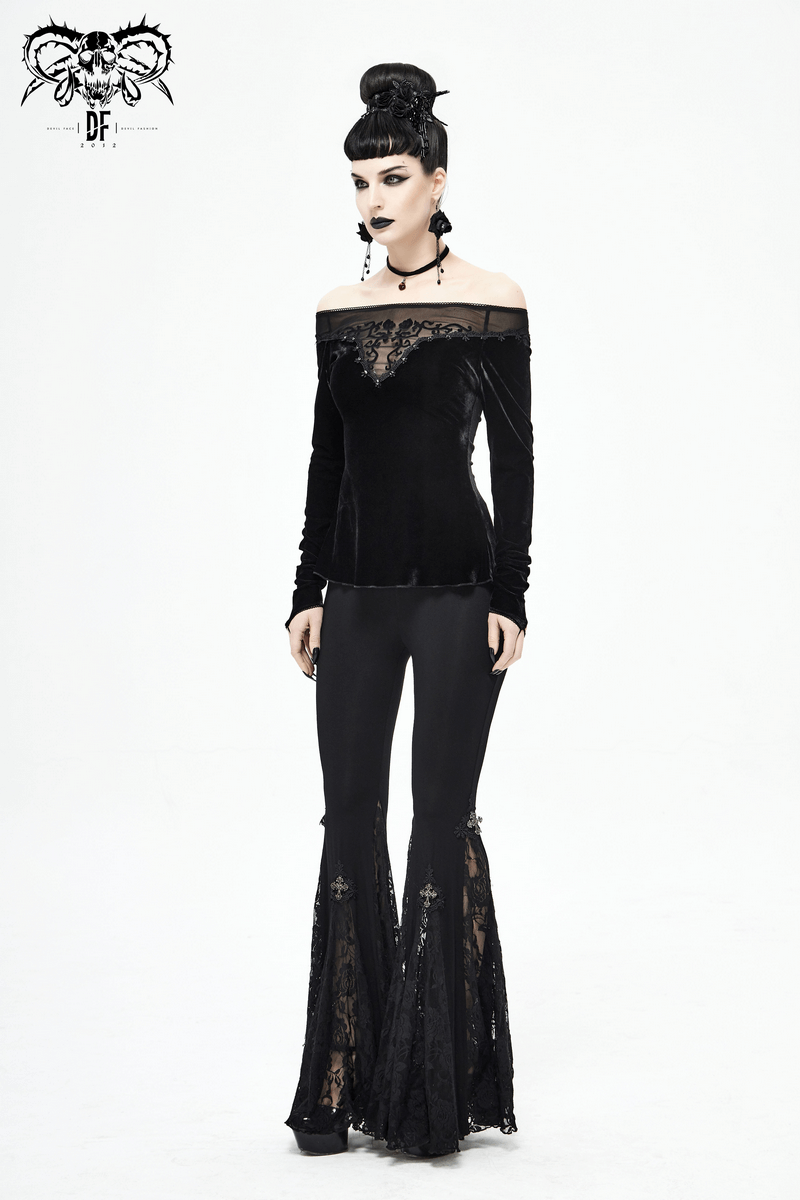 Elegant woman in gothic off-shoulder black velvet top and flared lace pants, showcasing vintage style and comfort.