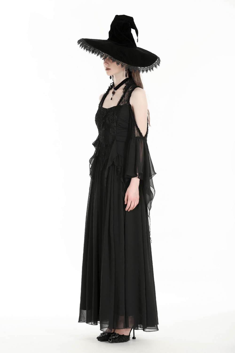 Gothic off-shoulder chiffon maxi dress with ruffle sleeves, styled with a dramatic witch hat.