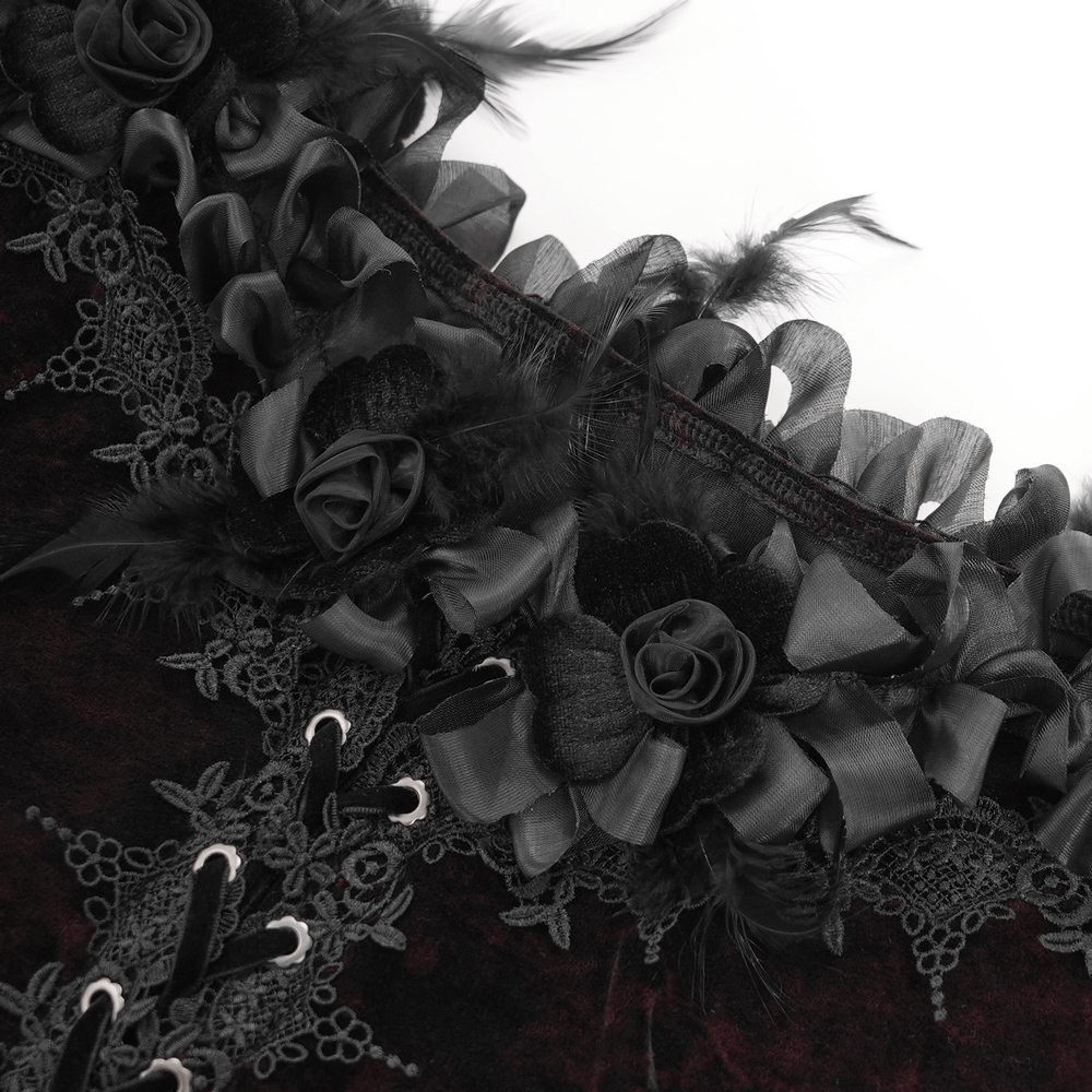 Close-up of gothic lace-up velvet blouse with black floral accents and ruffled lace trim.