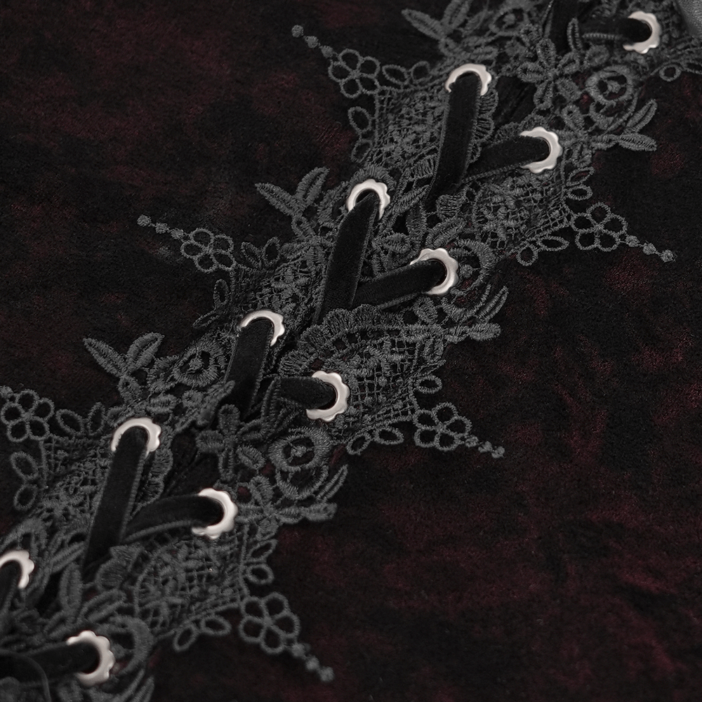 Close-up of gothic lace-up detail on velvet blouse showcasing intricate floral lace and ribbon accents.
