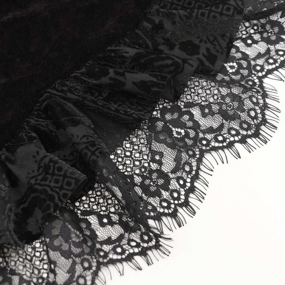Close-up of black velvet blouse with intricate lace trim and ruffled detailing, perfect for a gothic style.