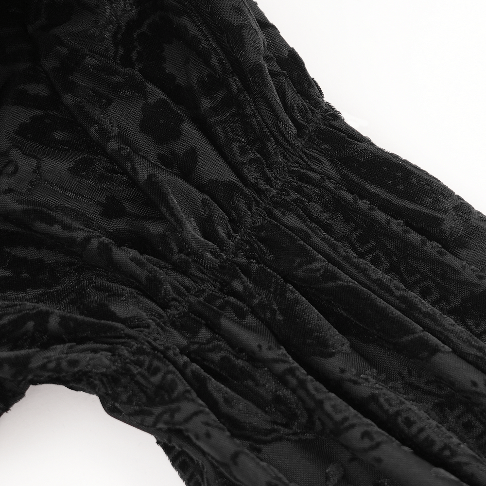 Close-up view of black velvet fabric showcasing intricate floral texture and lace details for gothic blouse.