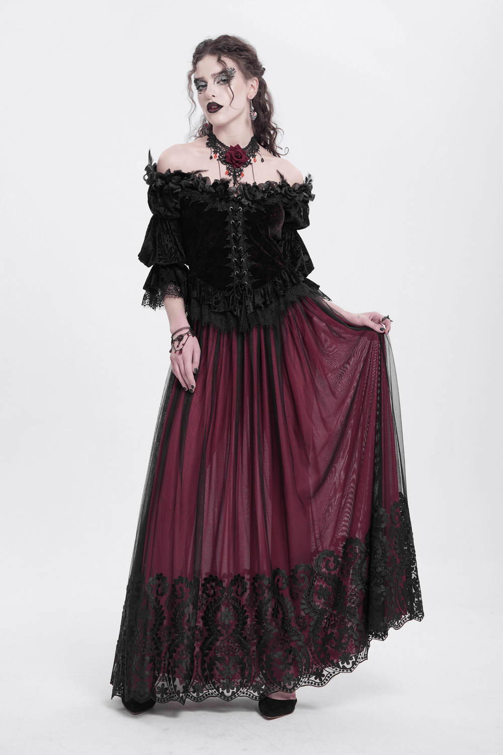 Gothic off-shoulder velvet blouse with ruffled sleeves, paired with a flowing burgundy skirt and intricate lace detailing.