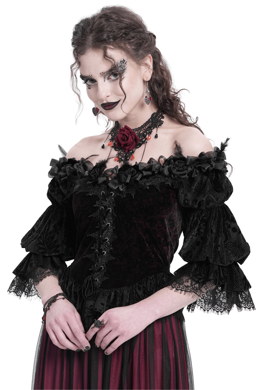 Gothic off-shoulder velvet blouse with lace-up detail and floral accents, paired with dramatic ruffled sleeves.