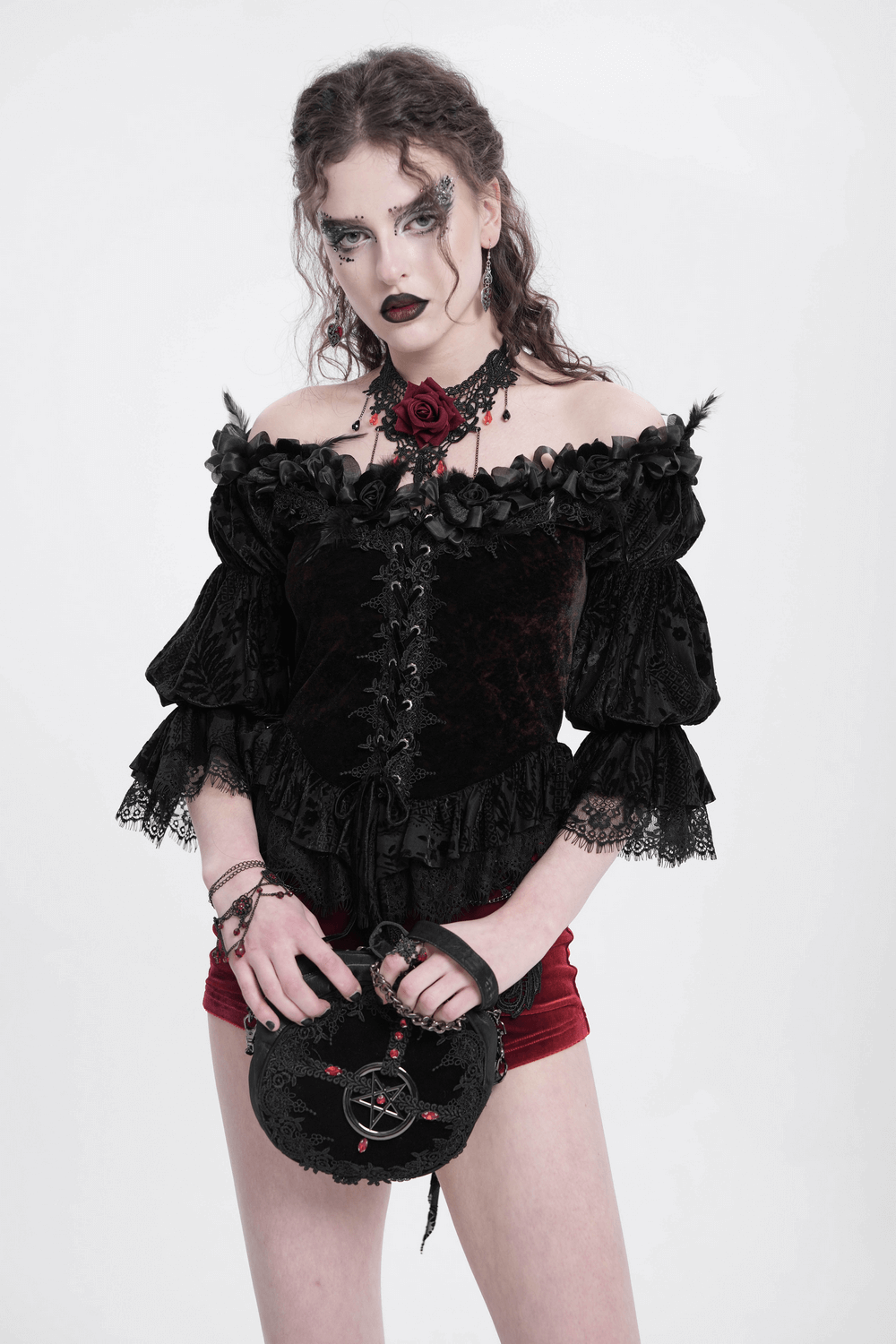 Gothic off-shoulder lace-up velvet blouse with floral accents and ruffled sleeves, perfect for dark romantic style.