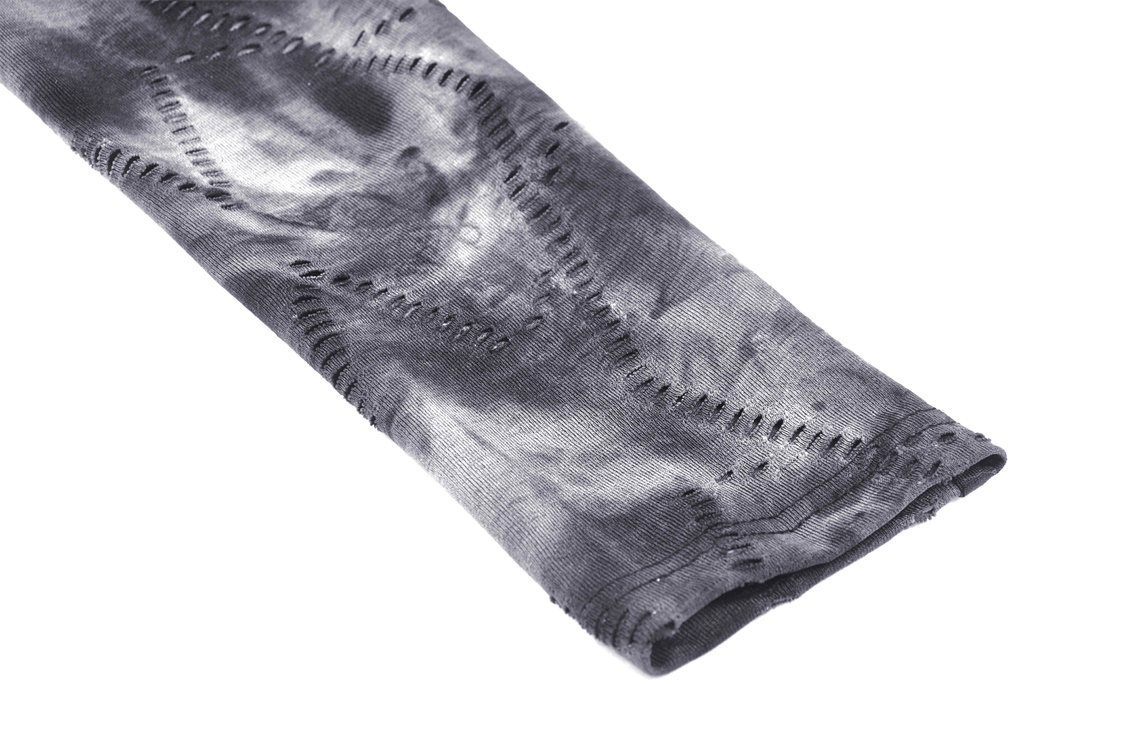 Close-up of a long sleeve gothic top in black and gray with edgy cutout detailing.