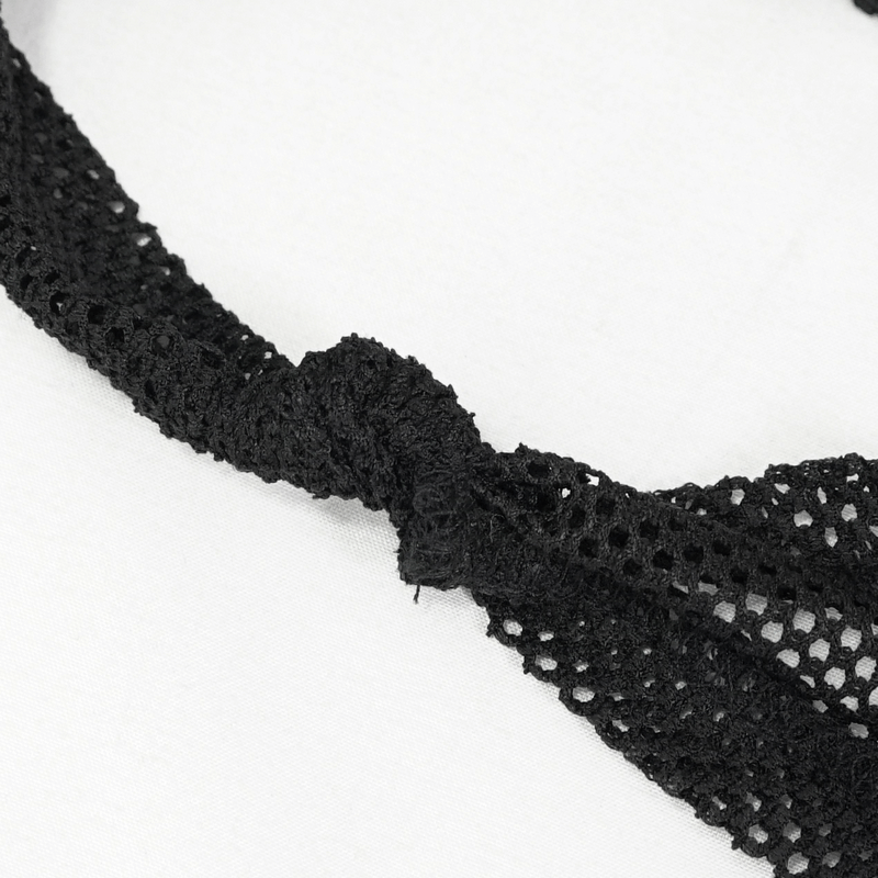Close-up of a stylish black mesh detail with a knot, perfect for a gothic off-shoulder top design.