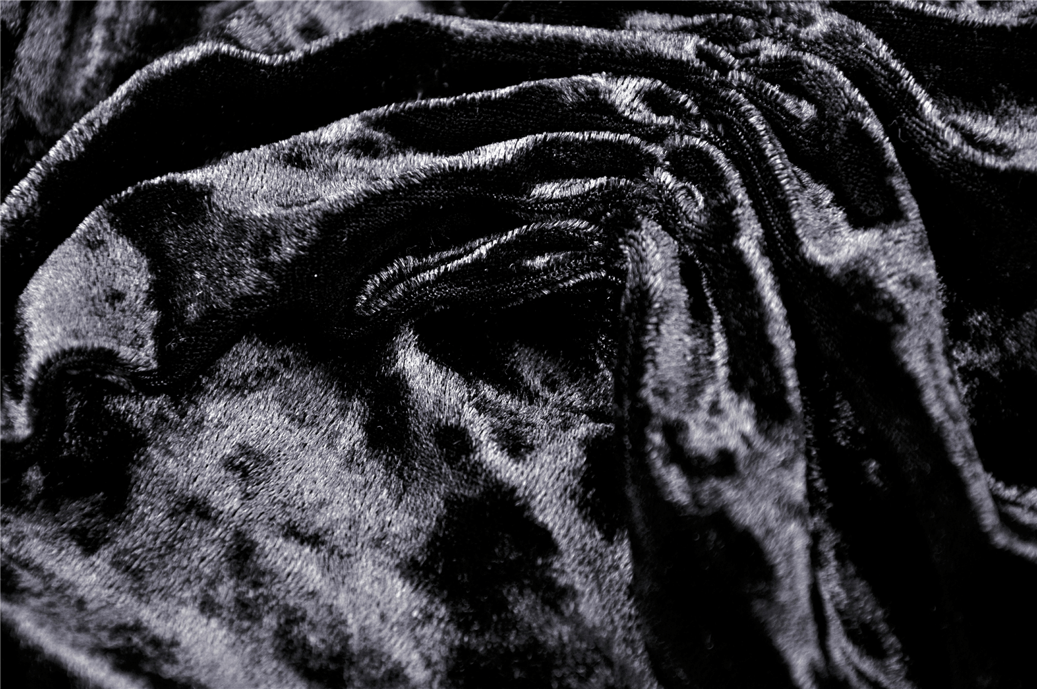 Close-up of luxurious black velvet fabric, perfect for gothic off-shoulder tops and alternative fashion.