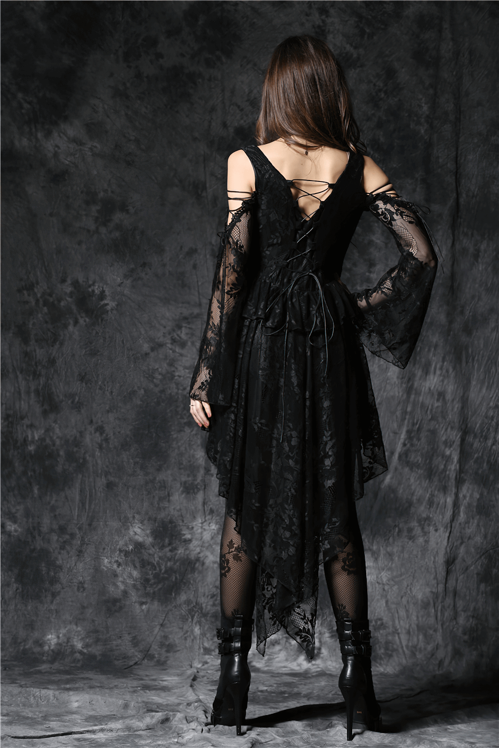 Back view of gothic off-the-shoulder lace dress with long sleeves and high-low hem for a chic look.