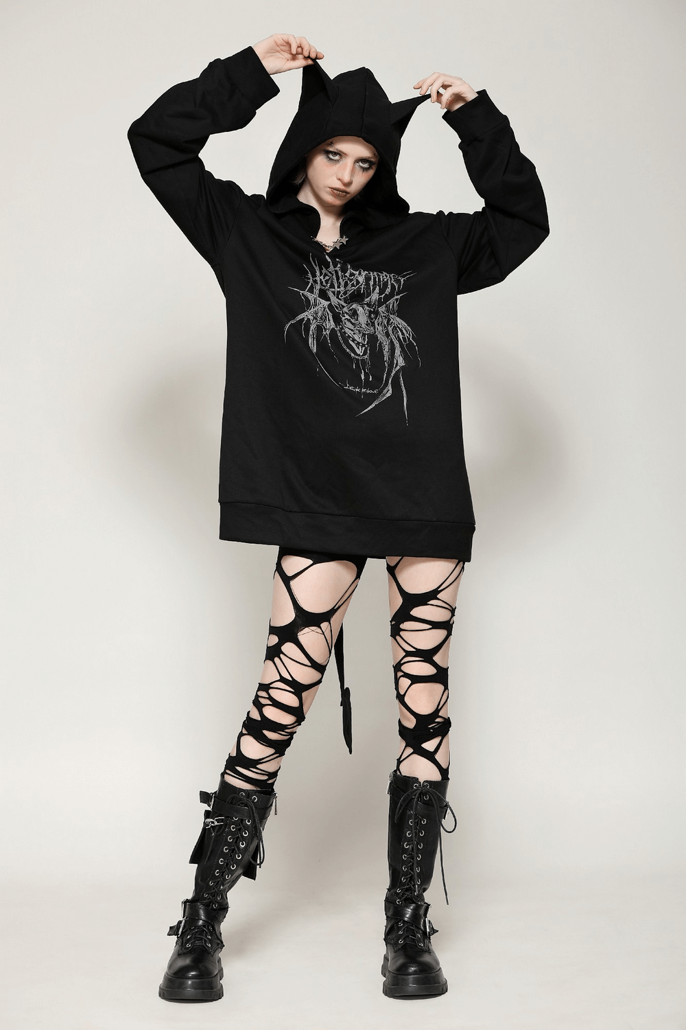 Gothic oversized hoodie with cat ears and devil tail, styled with edgy ripped leggings and combat boots. Perfect streetwear look!