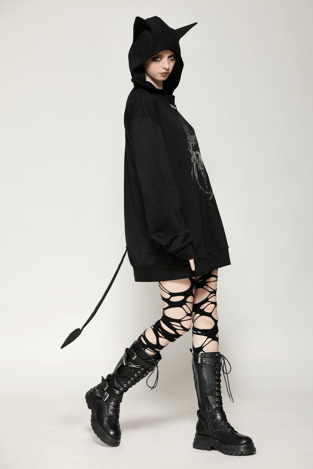 Gothic oversized hoodie with cat ears and devil tail, styled with edgy lace-up leggings and combat boots.