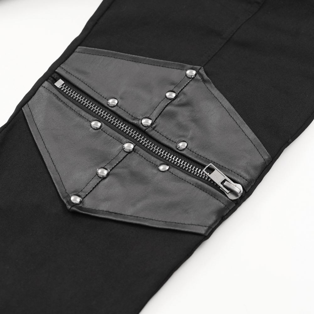 Close-up of gothic pants with leather panel, zipper, and metal studs for a bold streetwear style.