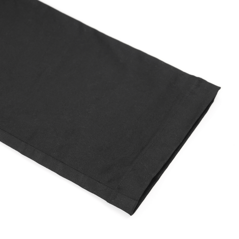 Close-up of black Gothic pants showcasing smooth fabric and tailored hem for fashionable streetwear.