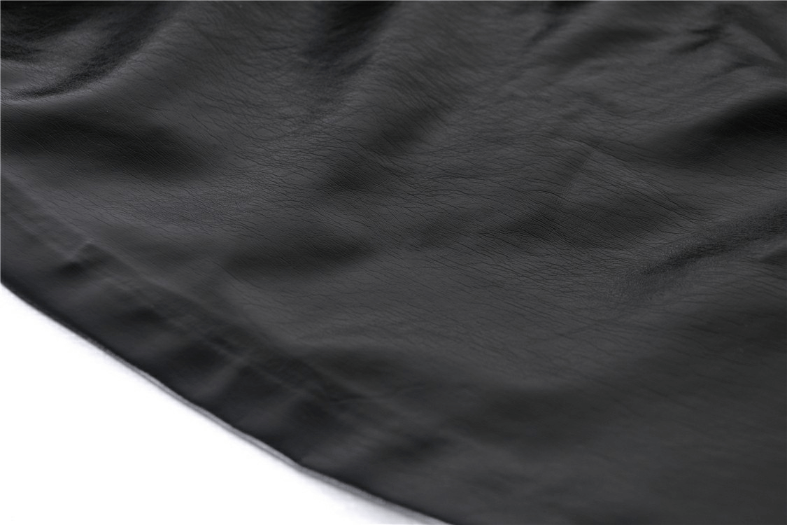Close-up of sleek black patent leather fabric showcasing texture and sheen of a gothic mini skirt.