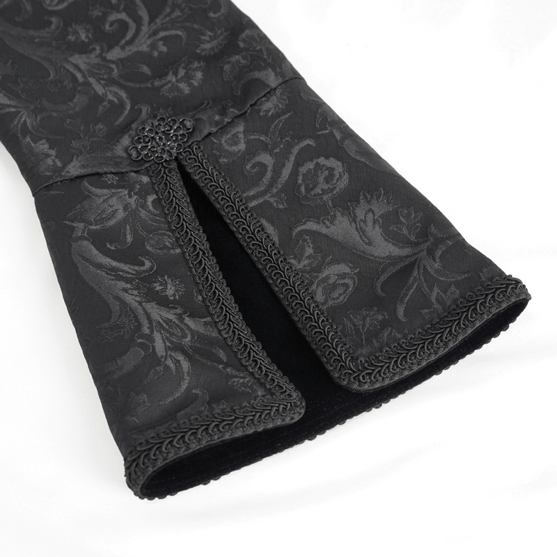 Close-up of gothic patterned black coat sleeve with elegant detailing and vintage charm.
