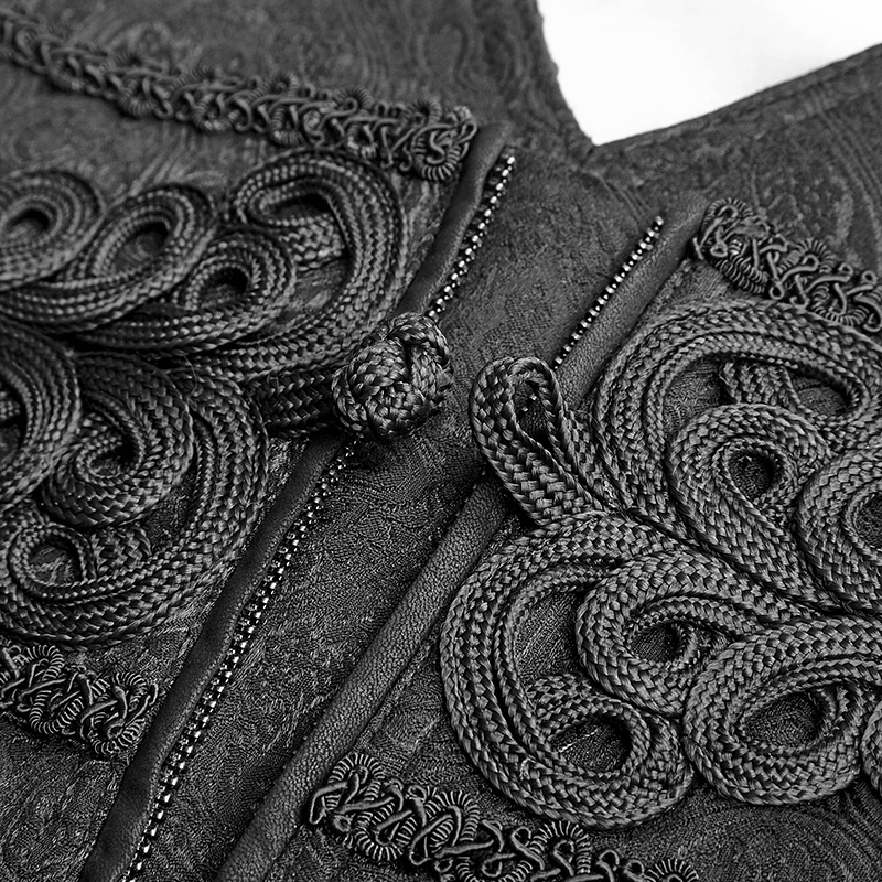 Detailed close-up of intricate black embroidery and ornate design on Gothic fabric.