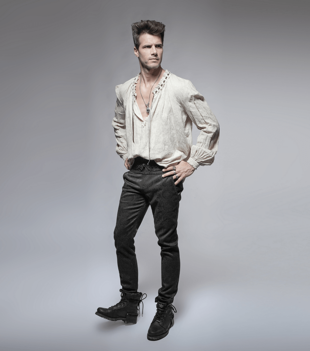 Man wearing elegant Gothic Jacquard Pants with ornate buttons and stylish top against a gray background.